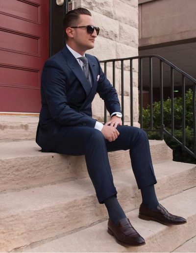 A Man with a Blue Suite Sitting on the Stairs - Custom Suits in Summit NJ